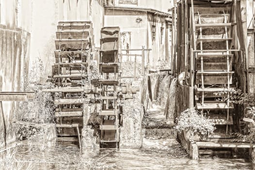 The carriages wheels of a water mill. Vintage style