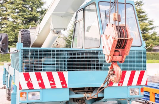 Truck crane, hook and pulley in the foreground