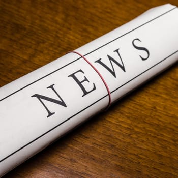 newspaper on wood desk