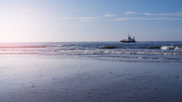 waves and ship at beach (north sea)