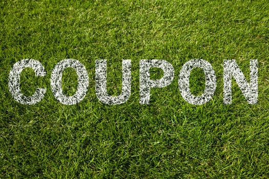 coupon written on a green meadow