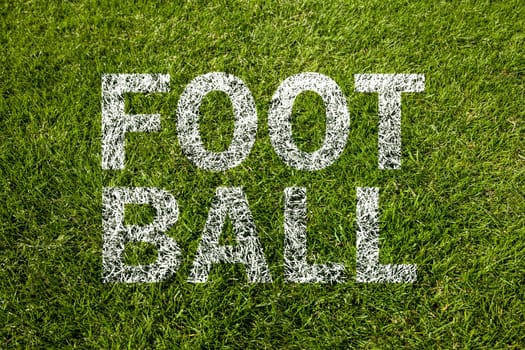 football text on a green meadow