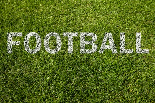 football written on green grass