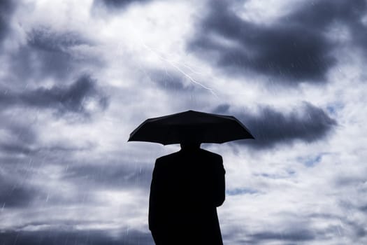business man and umbrella in storm