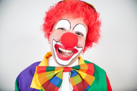 smiling clown with red hair on white