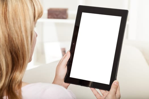 woman with tablet sitting on sofa