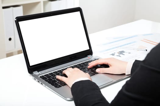 woman in office with laptop and white desk