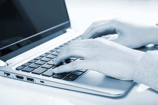 woman using laptop in blue color