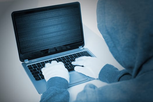 hacker on laptop in blue color