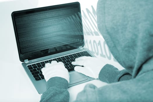 hacker on computer with white gloves