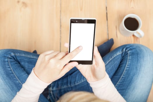 woman touching a smartphone with wooden floor