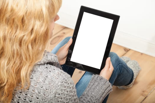 blond woman working on tablet at home