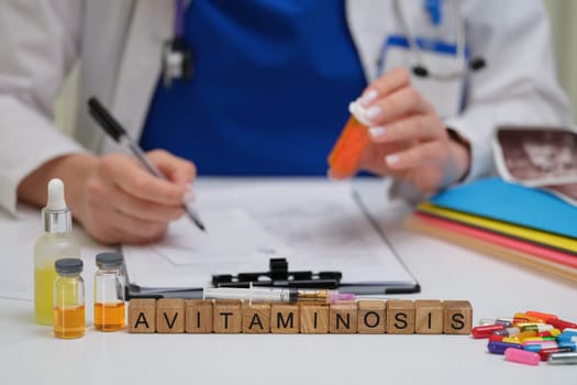 A healthcare professional thoroughly examines a case of avitaminosis using medical vials and taking detailed notes