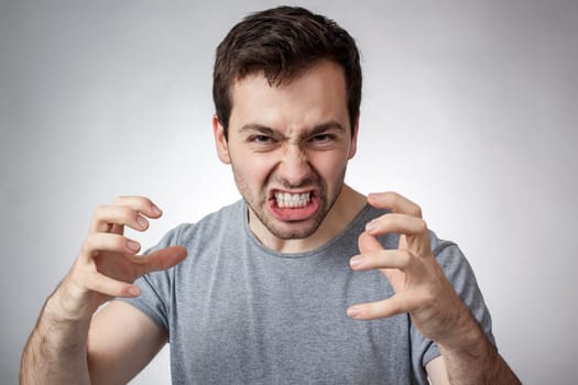 Angry young man clenching his teeth ready to pounce