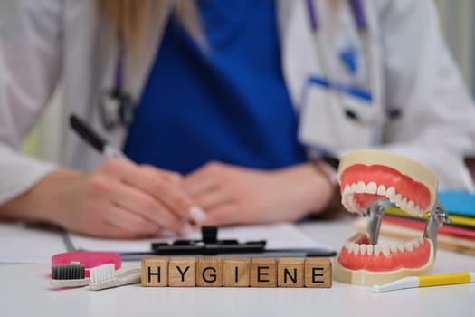 A dental expert highlights hygienes importance using specialized tools and models during patient consultations