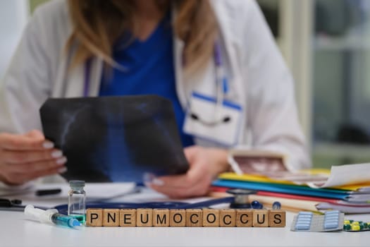 In a clinical environment, a healthcare professional carefully examines an Xray that is related to Pneumococcus