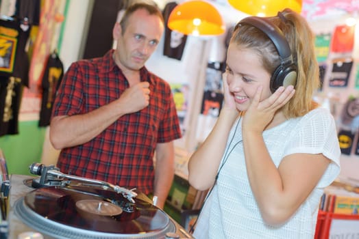 teen listening to the music on the records