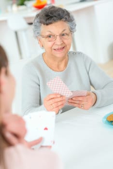Old lady playing a card game