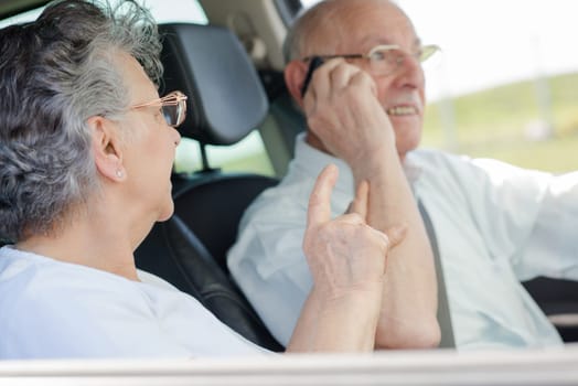 elderly couple in the car