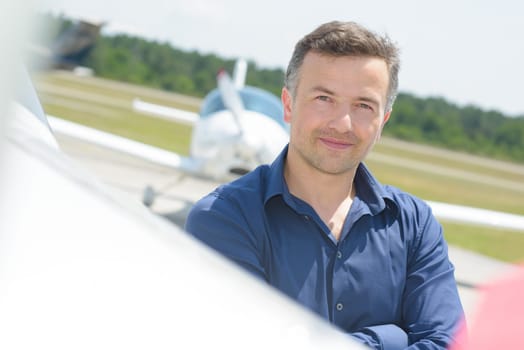 man with an airplane in the background