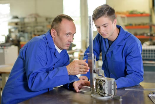 Technician and apprentice setting up equipment