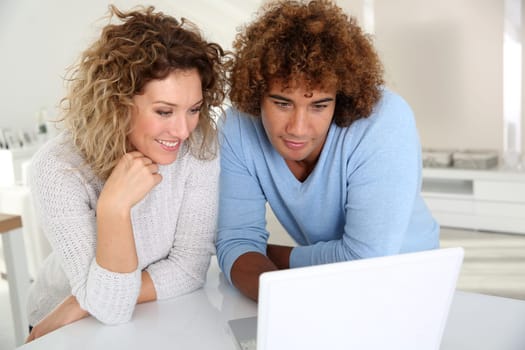 Couple websurfing on laptop computer