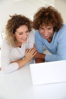Couple websurfing on laptop computer