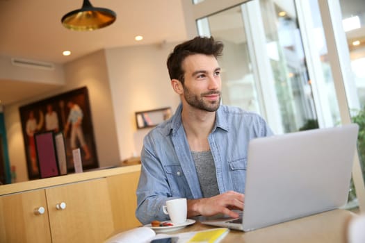 Man working on laptop computer from home