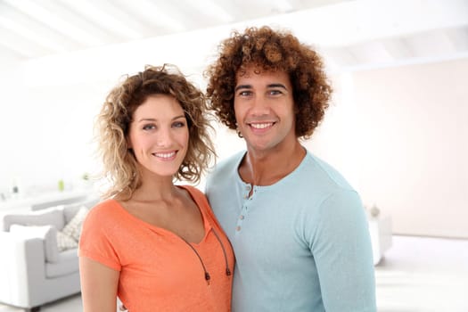Cheerful couple standing in their new place