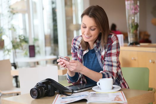 Brunette girl sending text message with smartphone