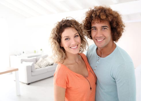 Cheerful couple standing in their new place