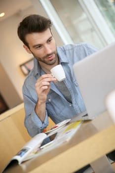Man working on laptop computer from home