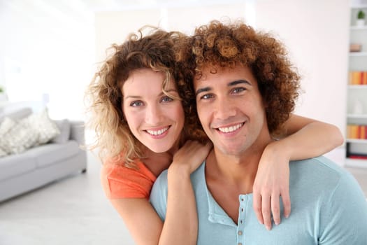 Cheerful couple standing in their new place
