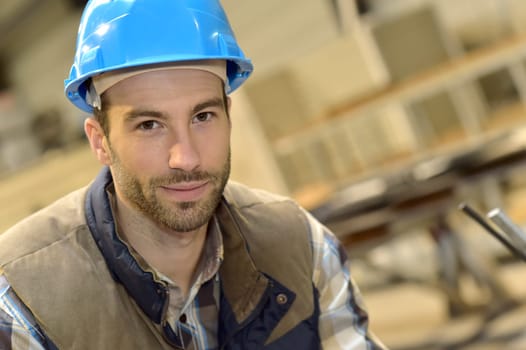 Portrait of industrial engineer wearing safety helmet