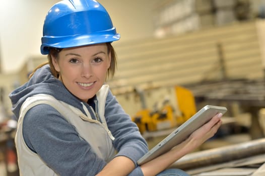 Wioman in manufacture using digital tablet