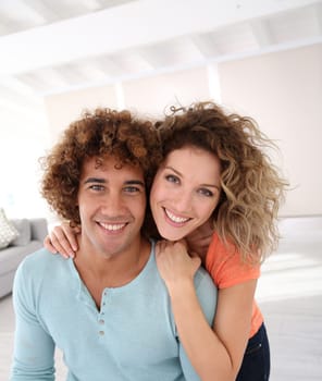 Cheerful couple standing in their new place