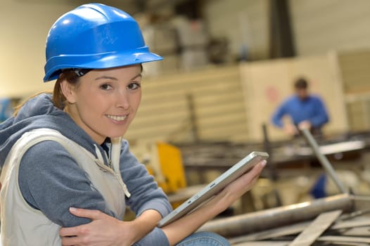 Wioman in manufacture using digital tablet