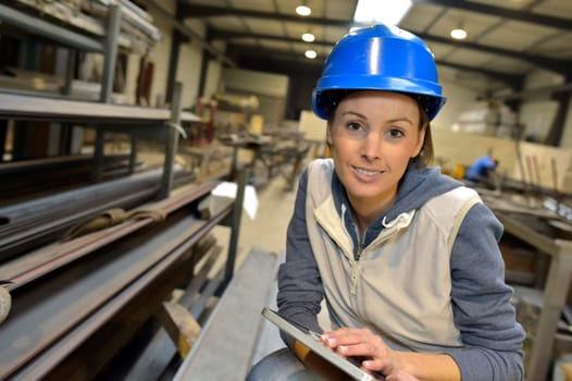 Woman engineer in steel plant checking production