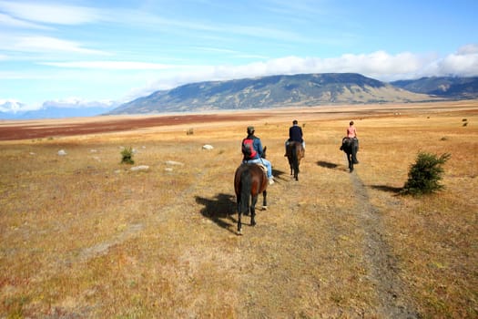 People riding horses in Patagonian steppe