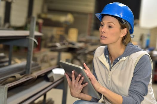 Woman engineer in steel plant using tablet