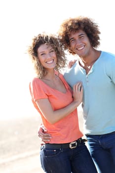 Smiling couple walking on the beach