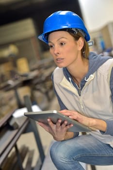 Woman engineer in steel plant using tablet