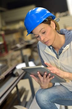 Woman engineer in steel plant using tablet