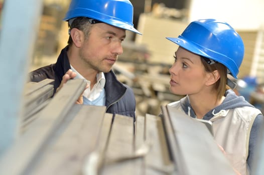 Supplier with engineer checking on production in factory