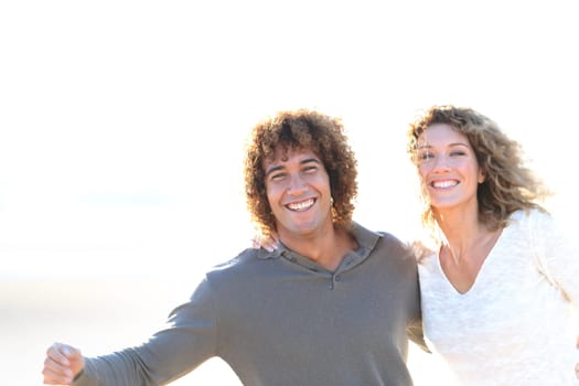 Cheerful couple running on the beach