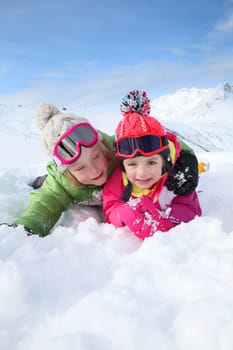 Portrait of kids enjoying winter vacation at ski resort