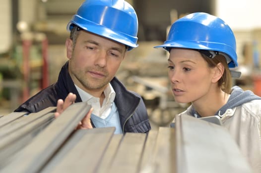Supplier with engineer checking on production in factory