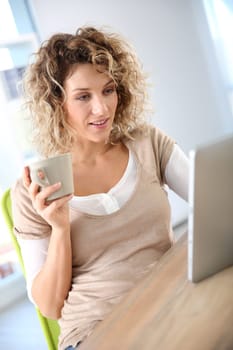 Woman in homr-office using tablet