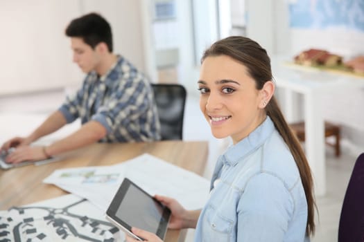 Portrait of student girl using digital tablet in class