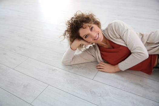 Woman laying on wooden modern flooring